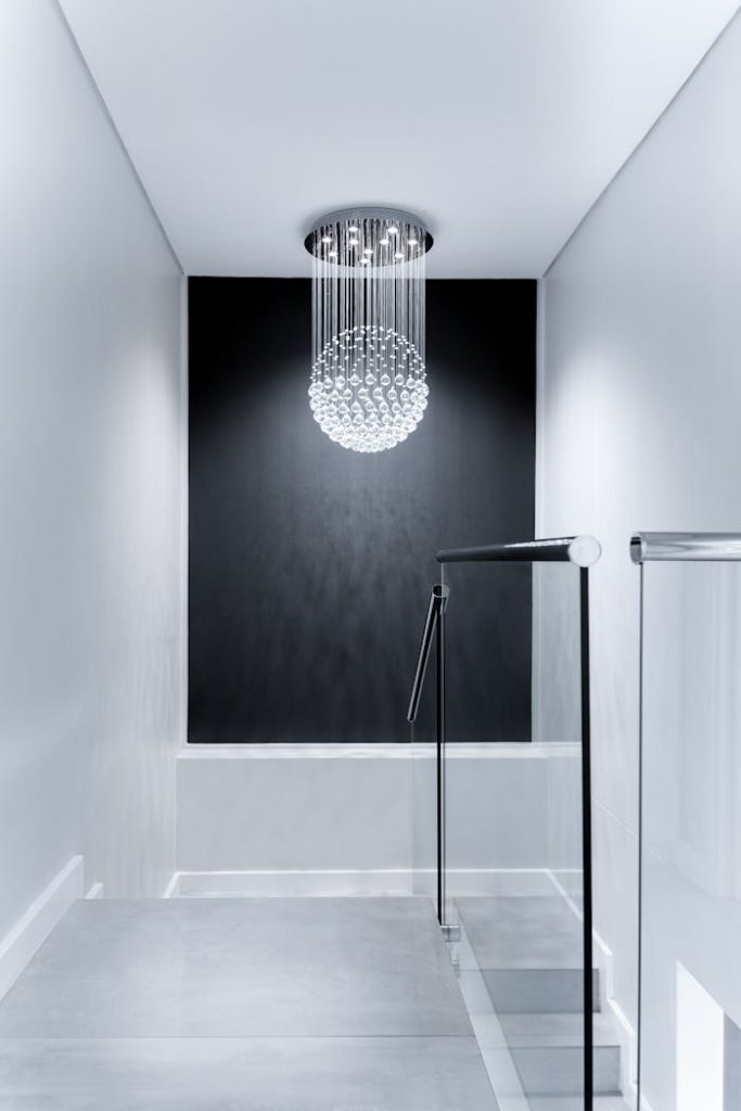 Sleek contemporary hallway featuring a stunning glass chandelier and minimalist design.