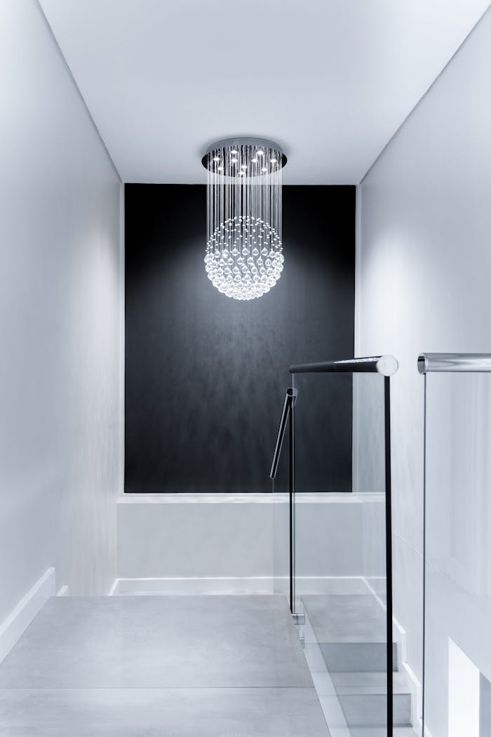 Sleek contemporary hallway featuring a stunning glass chandelier and minimalist design.